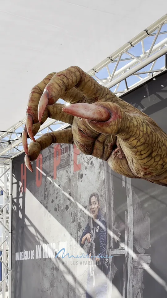 Creature hand reaching from a poster