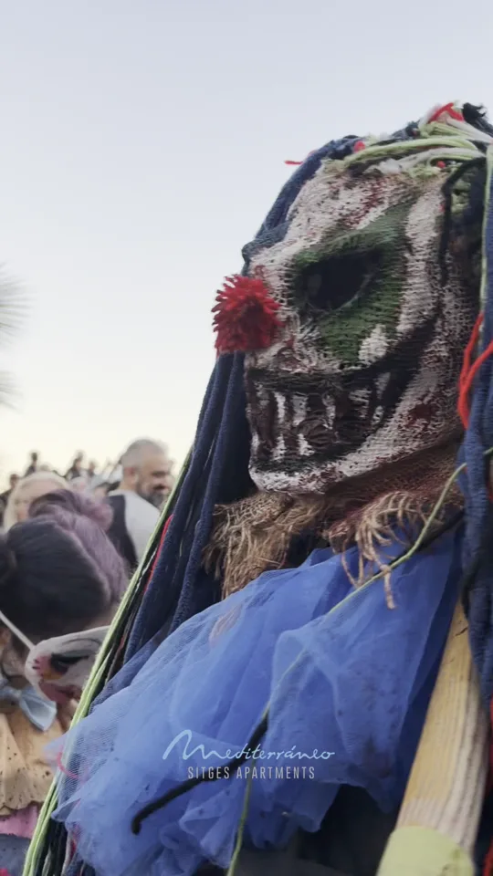 Masked creature with a red rose